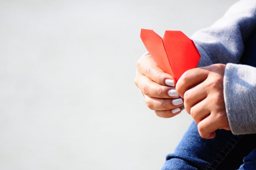 Hands Holding a Red Heart Shape Paper